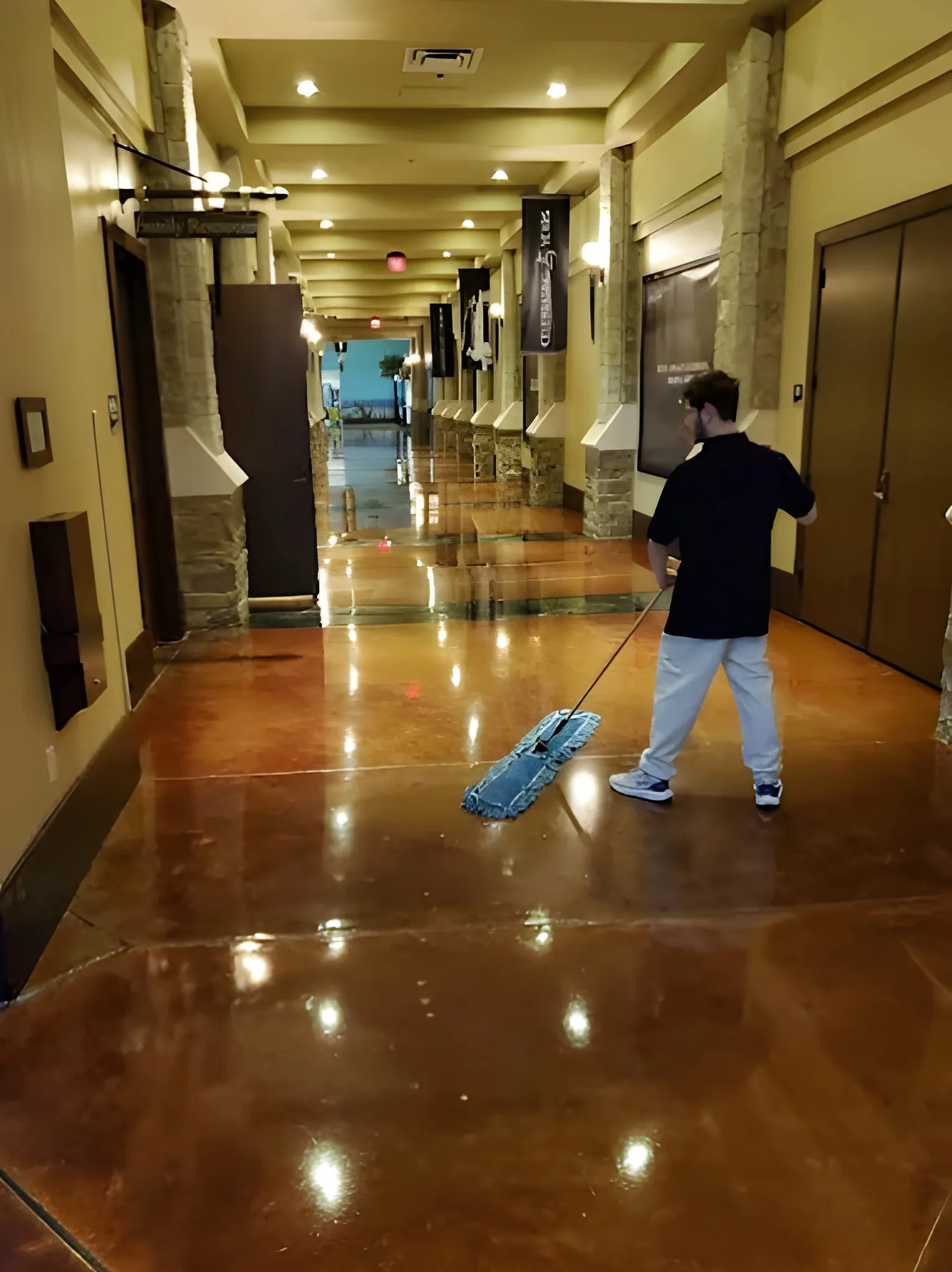 A Frisco Brothers crew member mopping a church corridor