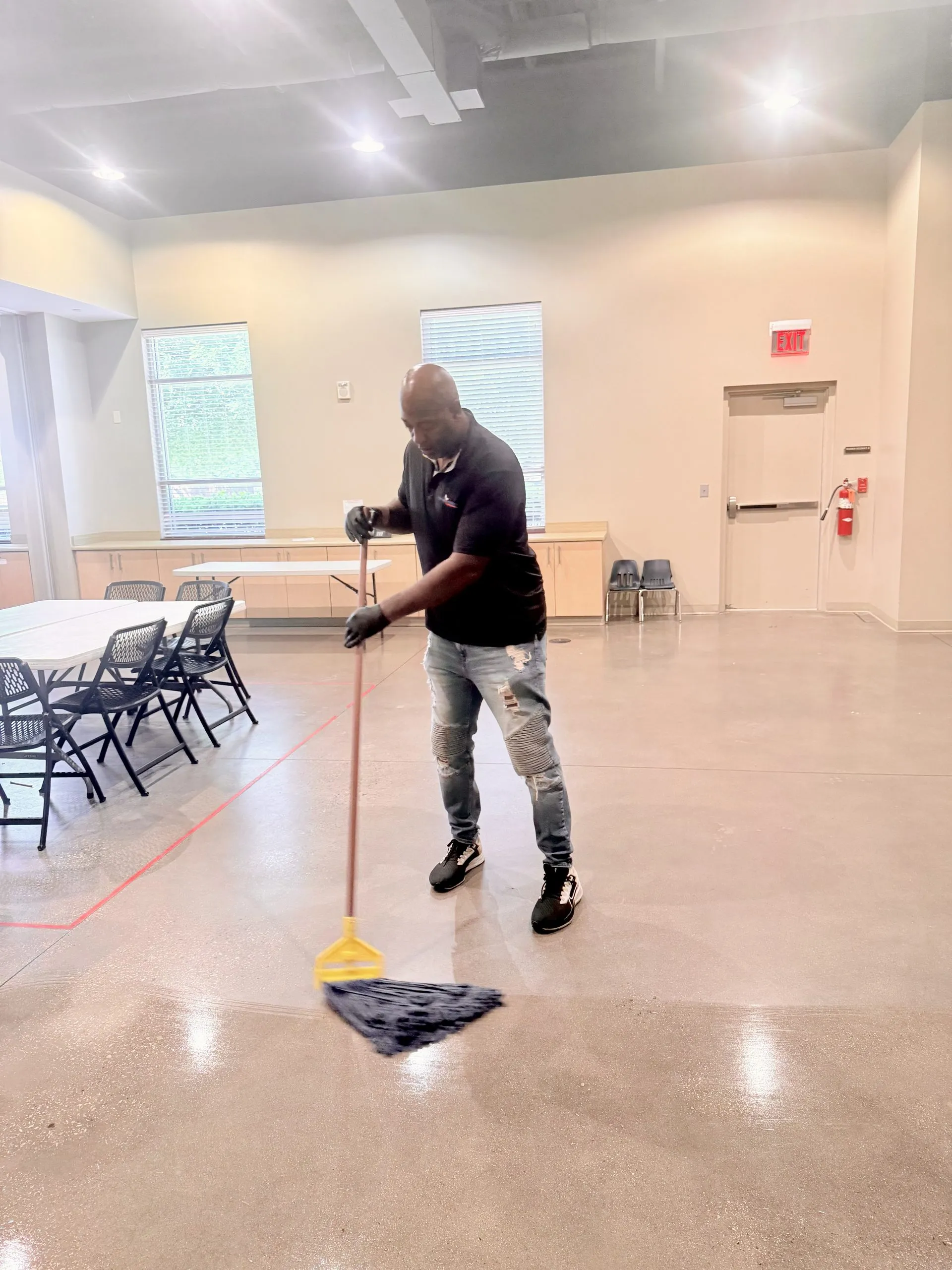 A mop and bucket on a commercial tile floor