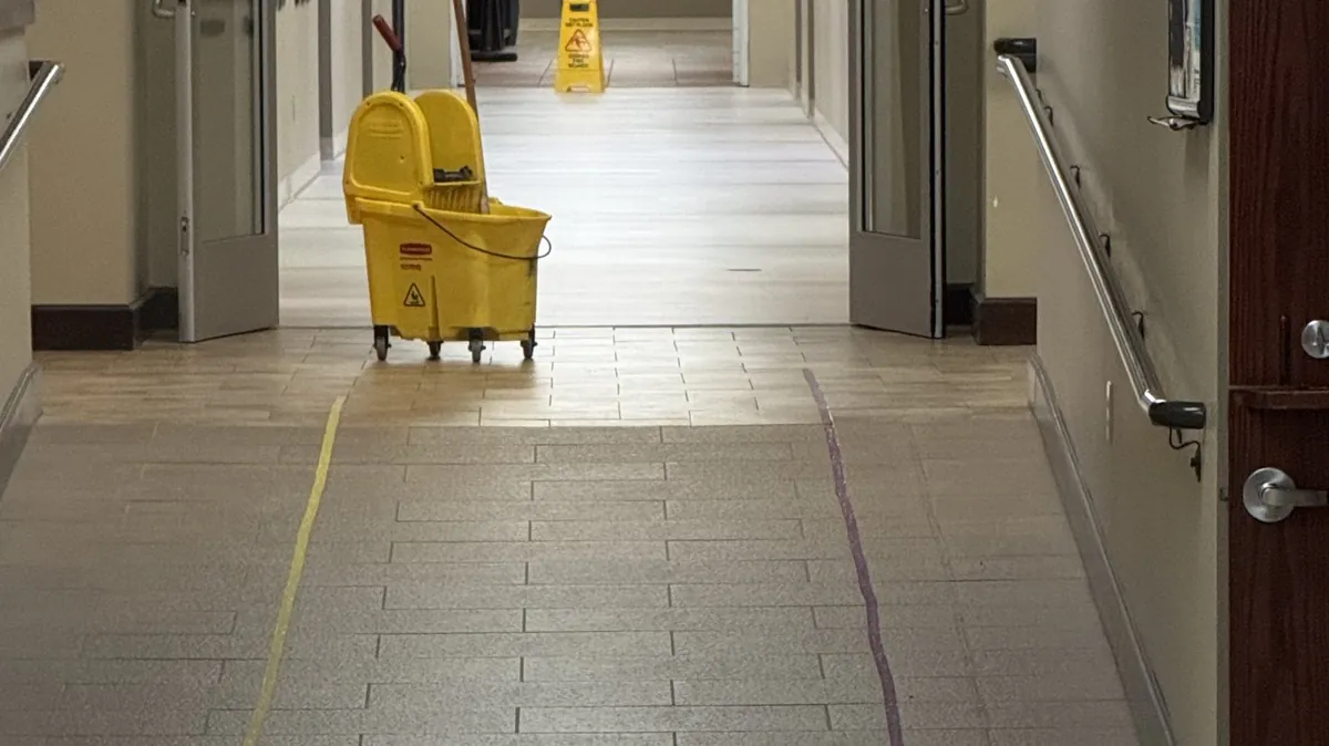 Frisco Brothers mopping a corridor at Grace Methodist Church between services